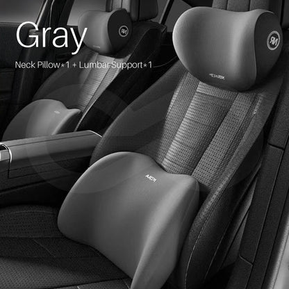 Gray color car neck pillow and lumbar support on a car seat.