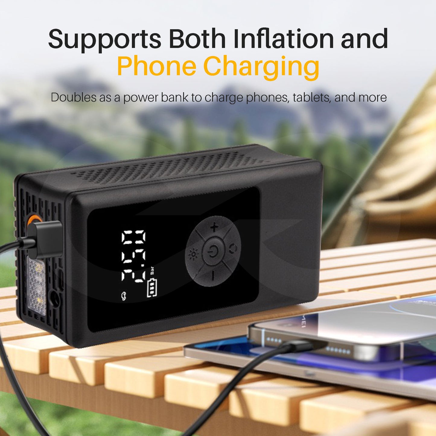 Portable wireless tire inflator on a wooden surface, charging a phone outdoors.