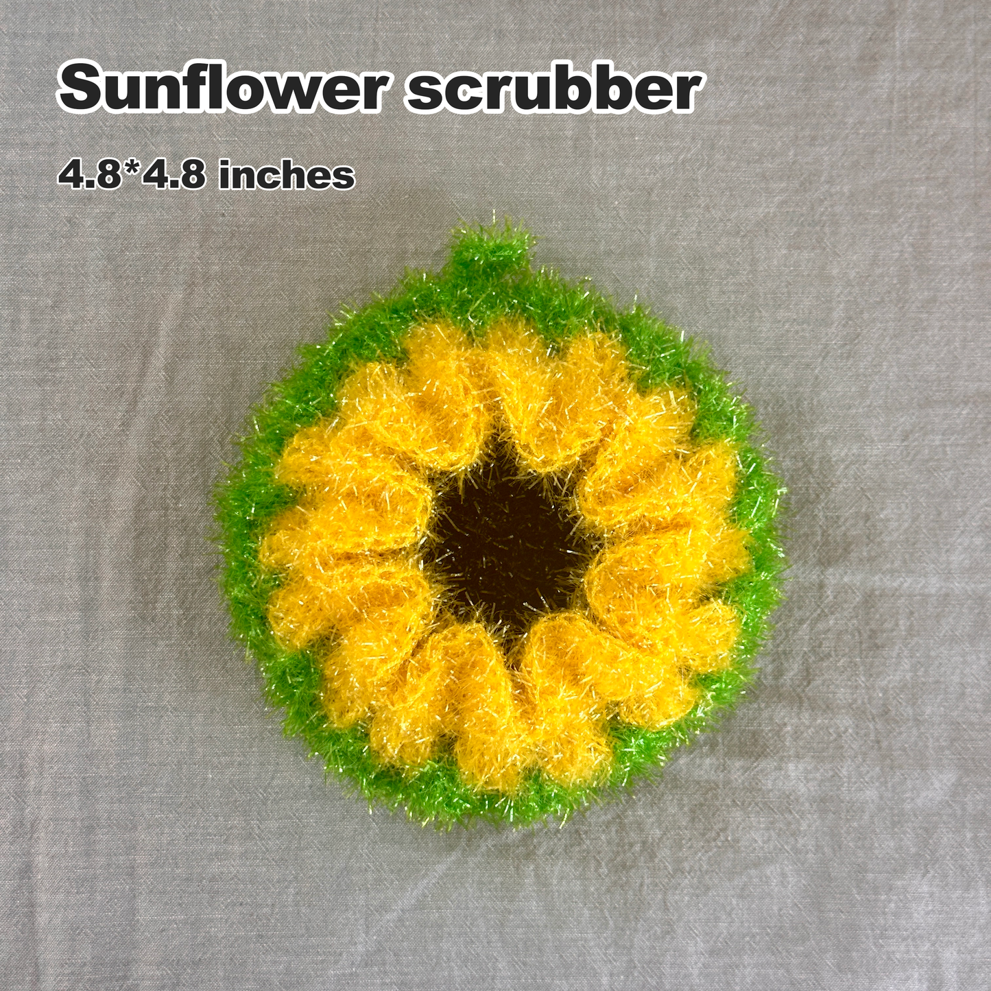 Sunflower-shaped scrubber with yellow center and green outer rim on a gray background