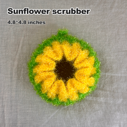 Sunflower-shaped scrubber with yellow center and green outer rim on a gray background