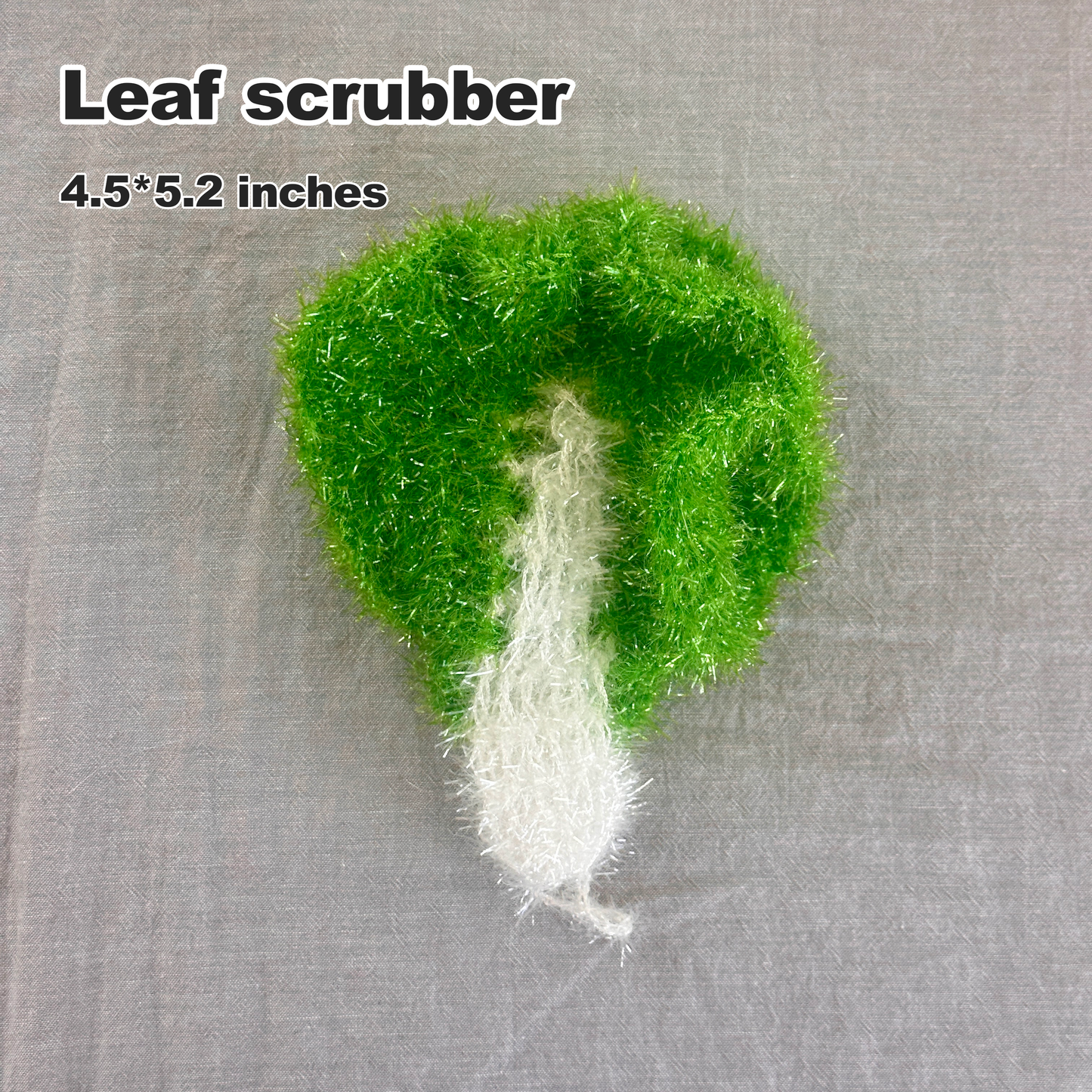 Green leaf-shaped scrubber on a gray background with text indicating size and type.
